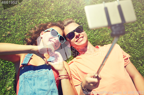 Image of happy couple taking selfie on smartphone at summer