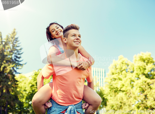 Image of happy teenage couple having fun at summer park