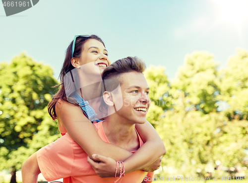 Image of happy teenage couple having fun at summer park