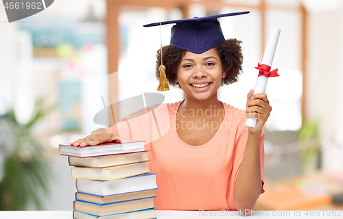 Image of african graduate student with books and diploma