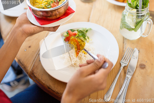 Image of woman eating at restaurant