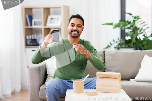 Image of indian man using smartphone for food delivery