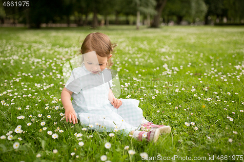 Image of happy little girl at park in summer