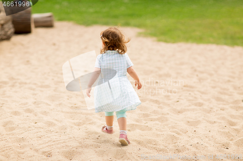 Image of little girl at children\'s playground in summer