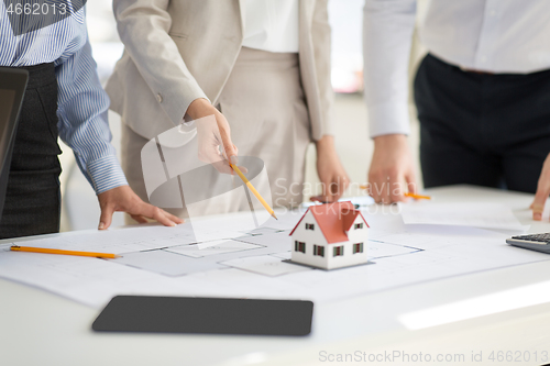 Image of close up of architects with blueprint at office