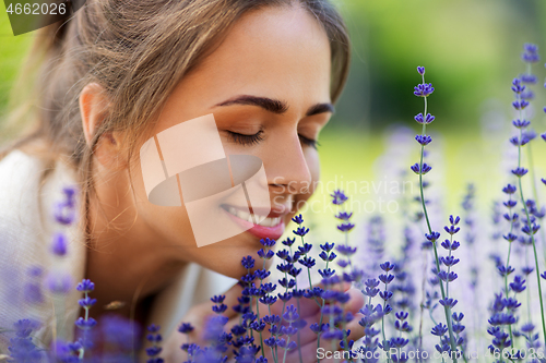 Image of close up of woman smelling lavender flowers