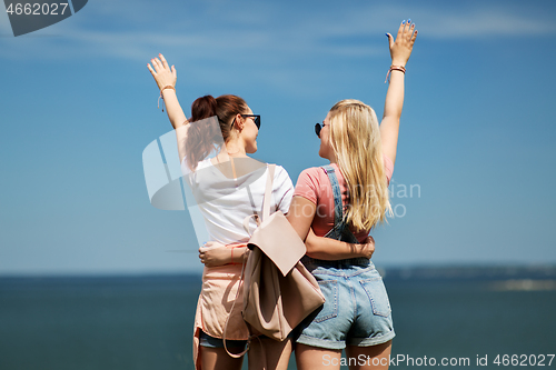 Image of teenage girls or best friends at seaside in summer