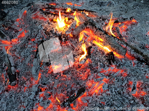 Image of Glowing embers of burning wood log fire