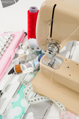 Image of Sewing machine, fabric and measurement tape