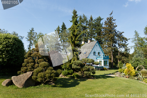 Image of Beautiful rural house in spring garden