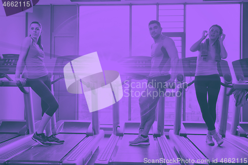 Image of Group of people running on treadmills