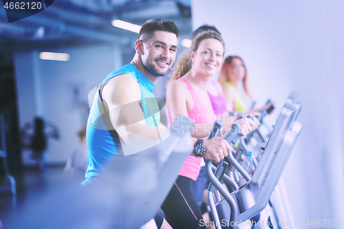 Image of Group of people running on treadmills