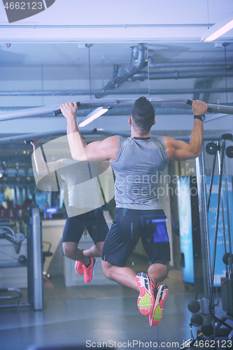 Image of handsome man exercising at the gym