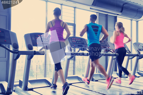 Image of Group of people running on treadmills