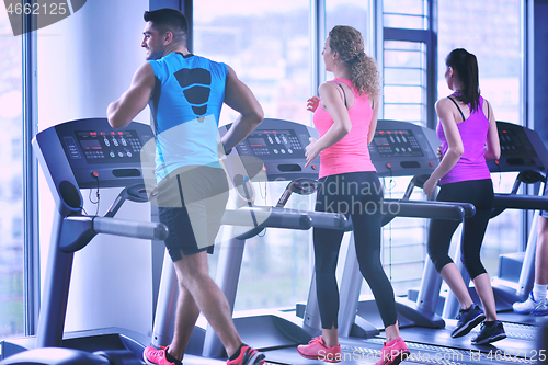 Image of Group of people running on treadmills