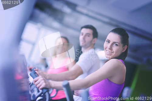 Image of Group of people running on treadmills