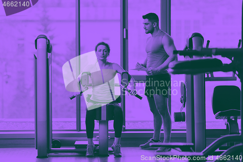 Image of woman exercising with her personal trainer