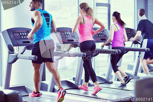 Image of Group of people running on treadmills