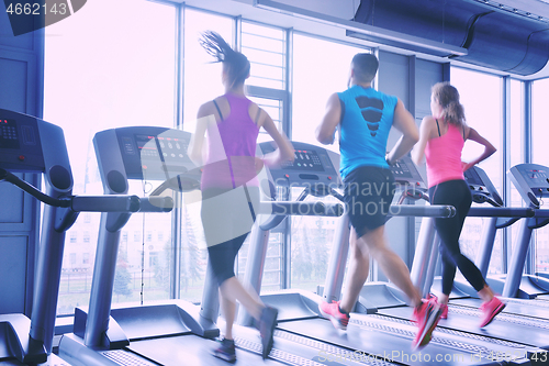 Image of Group of people running on treadmills