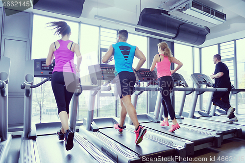 Image of Group of people running on treadmills