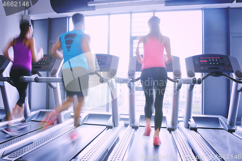 Image of Group of people running on treadmills