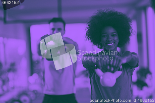 Image of couple  workout with weights at  crossfit gym