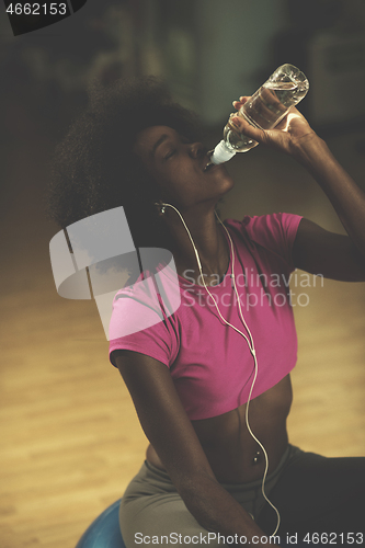 Image of young afro american woman in gym have pilates workout break