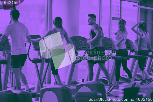 Image of Group of people running on treadmills