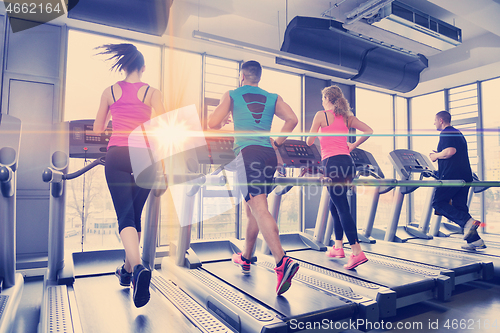 Image of Group of people running on treadmills