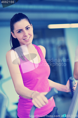 Image of woman exercising on treadmill in gym