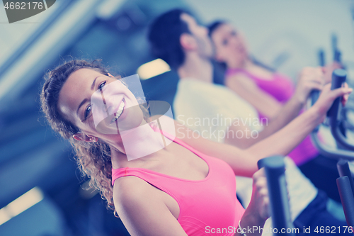 Image of Group of people running on treadmills