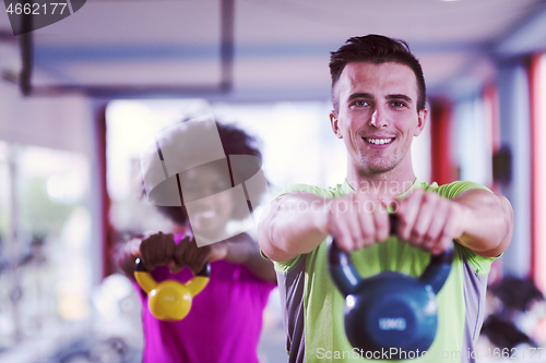 Image of couple  workout with weights at  crossfit gym