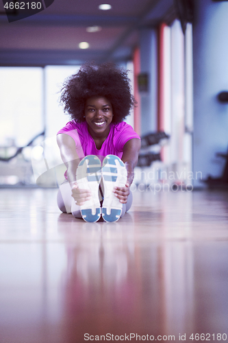 Image of woman in a gym stretching and warming up before workout