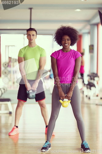 Image of couple  workout with weights at  crossfit gym