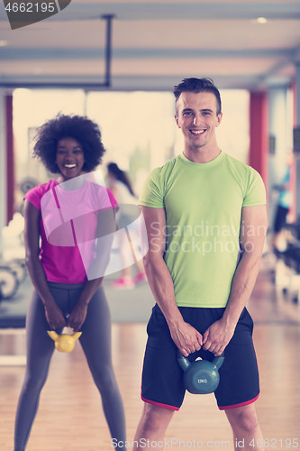 Image of couple  workout with weights at  crossfit gym