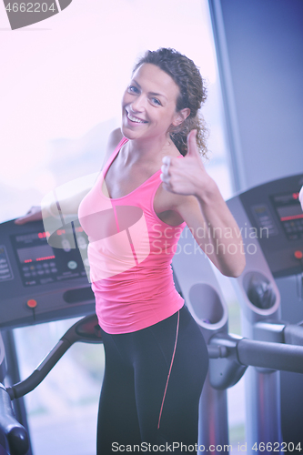 Image of woman exercising on treadmill in gym