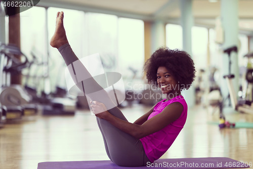 Image of african american woman exercise yoga in gym