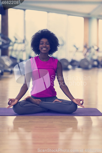 Image of african american woman exercise yoga in gym