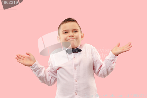 Image of Beautiful teen boy looking suprised and bewildered isolated on pink