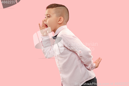 Image of Isolated on pink young casual boy shouting at studio