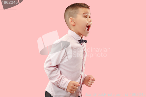 Image of Isolated on pink young casual boy shouting at studio