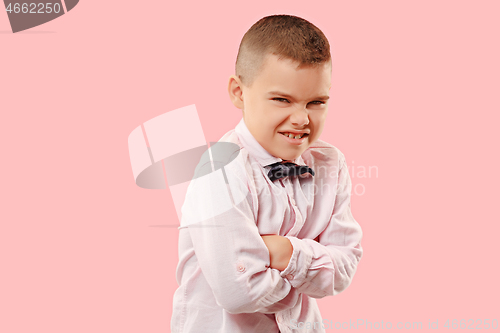 Image of The young emotional angry teen boy on pink studio background