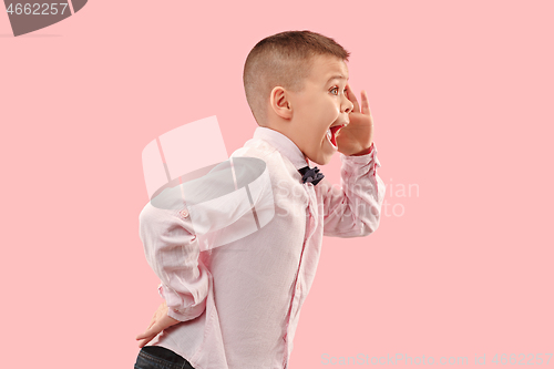 Image of Isolated on pink young casual boy shouting at studio