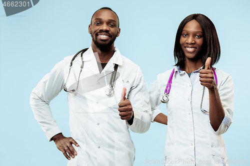 Image of The female and male happy afro american doctors on blue background