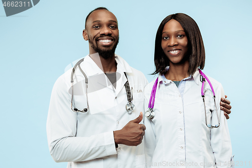 Image of The female and male happy afro american doctors on blue background