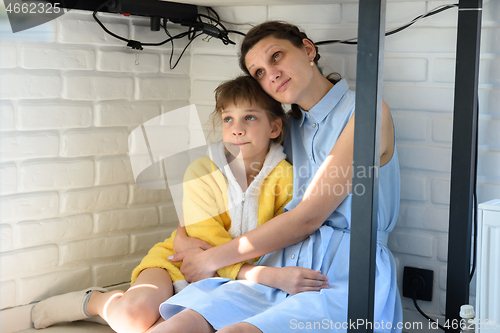 Image of Mom and daughter are sitting under the table