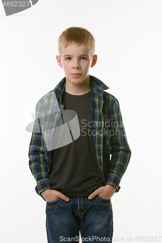 Image of Portrait of a boy of ten years in a plaid shirt and jeans