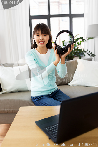Image of female blogger with headphones making video blog