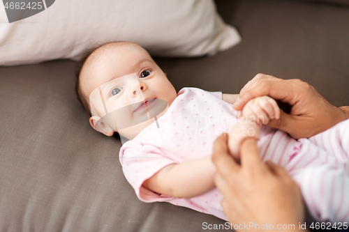 Image of middle aged father playing with baby at home