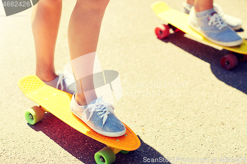 Image of close up of female feet riding short skateboard